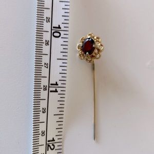 Goldtone and dark red hat pin